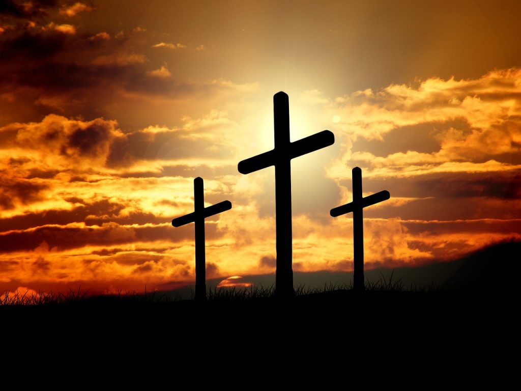 3 crosses against a sunset representing Christianity